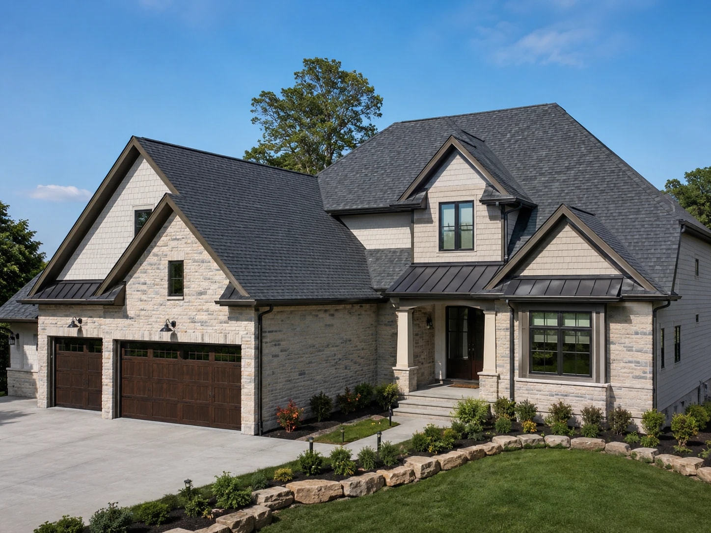 Residential home with dark asphalt shingle roofing, stone facade and attached garage.